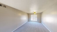 Located at 2701 Southwest Drive in Abilene, Texas, this 2-bedroom, 1-bathroom unit offers a functional and straightforward single-floor layout. The space is finished with wall-to-wall carpeting throughout the living and bedroom areas, neutral-toned walls, and textured ceilings that lend a consistent character across rooms. Ceiling fans with light fixtures are present in multiple rooms, providing both comfort and illumination. Natural light filters in through blinded windows in each room, contributing to a bright and airy feel. The spacious primary bedroom offers generous room for furnishings, complemented by a built-in closet with a shelf and hanging rod. The second bedroom, more intimate in scale, also features a ceiling fan and carpeted floors. The kitchen is equipped with dark cabinetry, light speckled countertops, a double-basin sink, and a window above the counter that allows in natural light. A dedicated closet provides additional storage within the unit. The bathroom includes a full tub-shower combination with a white surround enclosure and standard fixtures. Overall, the unit provides a practical and comfortable living environment suited for everyday use.