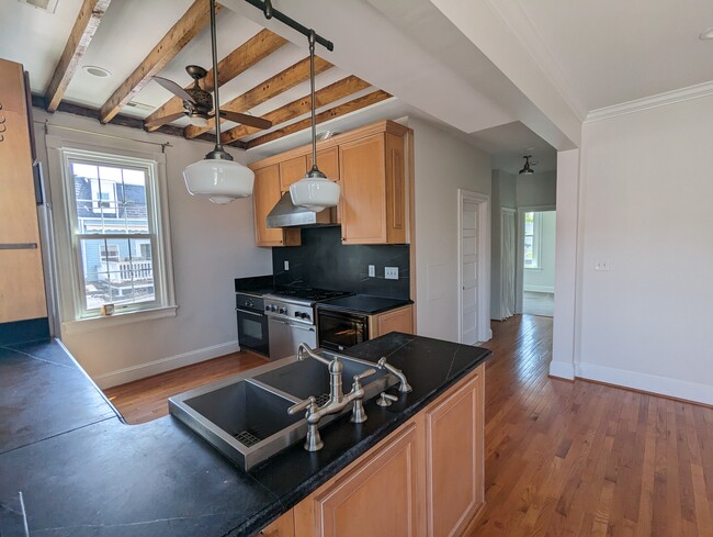 Chef's kitchen with soapstone countertops and high-end appliances. - 4413 GEORGIA AVE NW