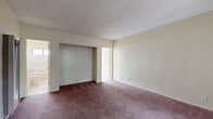 Located on Eagle Rock Boulevard in the Eagle Rock neighborhood of Los Angeles, this one-bedroom, one-bathroom unit offers a functional and efficient single-floor layout. The generously sized bedroom is the heart of the unit, featuring plush wall-to-wall carpeting in a warm mauve tone, neutral cream-colored walls, a textured ceiling, and a built-in closet with sliding doors. Natural light filters in through a window, and the room provides ample space for furnishings. The combined kitchen and dining area features light tile flooring, cream cabinetry, a countertop sink, and a window that looks out toward a verdant exterior, creating a bright and airy atmosphere. The bathroom is clean and straightforward, equipped with a full-size soaking tub with an overhead shower, a wall-mounted pedestal sink, a mirrored medicine cabinet, and a window that allows in natural light. Throughout the unit, a consistent cream and neutral palette creates a cohesive, understated aesthetic. The single-story layout ensures easy accessibility, and the overall design prioritizes practical use of every square foot within this compact yet well-organized living space.