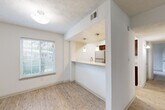 Located at 8601 Roberts Dr in Sandy Springs, GA, this single-story, 3-bedroom, 2-bathroom home offers a functional and well-appointed layout. The open living and dining area features light wood-style flooring and neutral white walls, creating a bright and welcoming atmosphere. Natural light filters through slatted blinds, enhancing the clean, airy feel throughout.

The kitchen is a standout feature, boasting granite countertops, rich dark-wood cabinetry, stainless steel appliances including a refrigerator, range, and microwave, and a peninsula with pendant lighting that opens toward the dining area — ideal for casual dining or entertaining.

The primary bedroom is generously sized with plush carpeting and ample closet space. The two additional bedrooms are also carpeted, offering comfortable and versatile spaces. Both bathrooms are finished with granite countertops, dark-wood vanities, and wood-style tile flooring, maintaining a consistent design aesthetic throughout.

A dedicated in-unit laundry room houses a full-size washer and dryer with overhead shelving. Three closets provide additional storage throughout the home. Textured ceilings are present in several rooms, adding a subtle architectural detail. The overall design is clean and cohesive, making this Sandy Springs home a practical and comfortable residence.