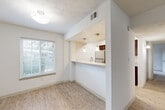 Located at 8601 Roberts Dr in Sandy Springs, GA, this single-story, 3-bedroom, 2-bathroom home offers a functional and well-appointed layout. The open living and dining area features light wood-style flooring and neutral white walls, creating a bright and welcoming atmosphere. Natural light filters through slatted blinds, enhancing the clean, airy feel throughout.

The kitchen is a standout feature, boasting granite countertops, rich dark-wood cabinetry, stainless steel appliances including a refrigerator, range, and microwave, and a peninsula with pendant lighting that opens toward the dining area — ideal for casual dining or entertaining.

The primary bedroom is generously sized with plush carpeting and ample closet space. The two additional bedrooms are also carpeted, offering comfortable and versatile spaces. Both bathrooms are finished with granite countertops, dark-wood vanities, and wood-style tile flooring, maintaining a consistent design aesthetic throughout.

A dedicated in-unit laundry room houses a full-size washer and dryer with overhead shelving. Three closets provide additional storage throughout the home. Textured ceilings are present in several rooms, adding a subtle architectural detail. The overall design is clean and cohesive, making this Sandy Springs home a practical and comfortable residence.