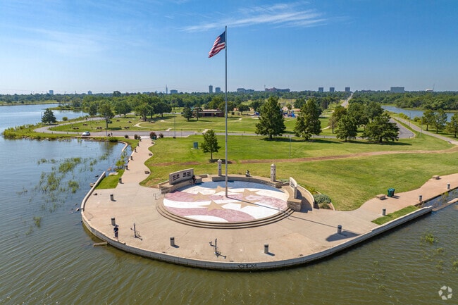 The large Stars and Stripes flagpole that sits lakeside at the Stars and Stripes Park.