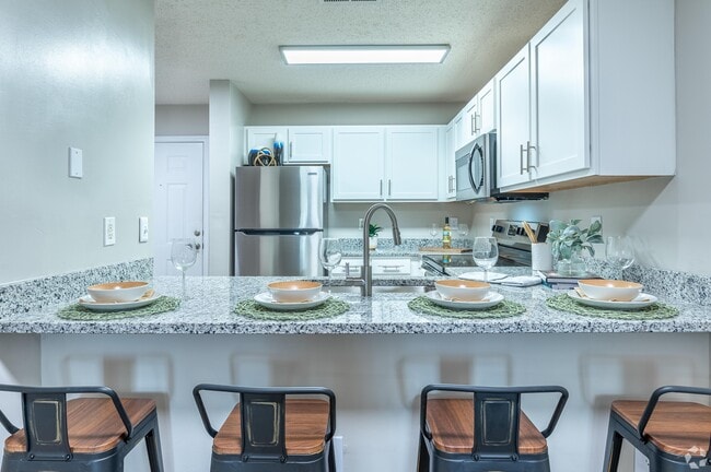 Kitchen with granite counters and stainless appliances - The Ashton