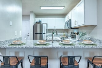 Kitchen with granite counters and stainless appliances - The Ashton