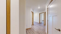 Located at 2040 Maxwell Dr in Hudson, WI, this single-floor, 2-bedroom, 1-bathroom unit offers a well-designed layout with a clean, neutral aesthetic throughout. Light wood-tone laminate flooring and warm oak-toned trim flow consistently across every room, creating a cohesive and inviting atmosphere.

The kitchen is a standout feature, offering generous counter space, light maple cabinetry, and a full suite of stainless steel appliances including a gas range, built-in microwave, refrigerator, and dishwasher. Recessed lighting and a window bring natural light into the space.

The open living area includes a wall-mounted mini-split HVAC unit and sliding glass doors with vertical blinds that lead directly to a private patio, providing easy outdoor access and natural light. A secondary window adds additional brightness to the room.

The primary bedroom is a comfortable size, featuring a ceiling fan, a large window with outdoor views, and ample closet space with bifold doors. The second bedroom is also well-proportioned with its own closet.

The bathroom is equipped with an accessible walk-in shower featuring stainless steel grab bars. Additional highlights include abundant closet storage throughout, a dedicated laundry area, and a practical hallway connecting all rooms efficiently.