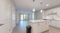 Located at 7350 Honore Ave in Sarasota, Florida, this well-appointed 2-bedroom, 2-bathroom residence offers a thoughtfully designed single-level layout with modern finishes throughout. Light-toned wood-look flooring runs continuously across the entire home, creating a cohesive and clean aesthetic.

The open-concept kitchen and living area serves as the heart of the home. The kitchen features white shaker-style cabinetry extending to the ceiling, granite countertops, a subway tile backsplash, stainless steel appliances including a range, microwave, and refrigerator, a deep undermount sink, and a central island with pendant lighting — ideal for both cooking and casual dining. The living area is bright and airy, benefiting from multiple windows and a ceiling fan, with direct access to a private balcony.

The primary bedroom is generously sized with a ceiling fan and ample natural light. Its en-suite bathroom offers a granite-topped vanity, wood-toned cabinetry, a walk-in shower, and direct access to a spacious walk-in closet with wire shelving. The second bedroom is well-proportioned and connects conveniently to the second full bathroom, which includes a soaking tub and shower combination. Three closets in total provide excellent storage throughout. A dedicated laundry room completes this well-rounded home.