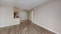 Located at 3202 N Country Club Rd in Tucson, AZ, this well-appointed one-bedroom, one-bathroom unit offers a practical and comfortable single-floor layout. Throughout the space, wood-style laminate flooring provides a cohesive, easy-to-maintain surface, complemented by neutral beige tones on the walls and white baseboards.

The open living room and kitchen area serves as the heart of the unit. The living room features a ceiling fan, textured ceilings, and a sliding glass door that opens onto a private balcony, allowing natural light to flow in and providing outdoor views of the surrounding property. The adjacent kitchen is efficiently arranged in a galley style, equipped with dark appliances including a refrigerator and range, gray cabinetry, and light countertops.

The bedroom is a comfortably sized private retreat with a window dressed with blinds, textured ceiling, and access to a dedicated closet for storage. A door from the bedroom leads directly to the bathroom, which includes a full tub-shower combination and a vanity with warm-toned cabinetry.

This unit offers a straightforward, functional layout that makes efficient use of its space, ideal for those seeking a comfortable residence in Tucson's central corridor.
