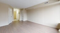 Located at 210 Somerset St W in Ottawa's vibrant Centretown neighbourhood, this studio unit offers a smartly designed, single-floor layout that maximizes every square foot. The open-concept living and dining area is anchored by a large picture window that frames views of the surrounding urban streetscape, flooding the space with natural light. Light-toned laminate flooring runs throughout, contributing to a clean, airy aesthetic complemented by neutral warm-beige walls and white trim.

The kitchen is efficiently laid out with white cabinetry featuring sleek bar-pull hardware, a white coil-top range, and light countertops — all set beneath a drop ceiling with recessed panelling. A short hallway connects the main living area to the remaining rooms, with doors leading to the bathroom and a dedicated closet for storage.

The bathroom is finished with tile flooring, a white vanity with under-sink cabinetry and a mirrored medicine cabinet above, providing practical storage solutions. The entry corridor offers a welcoming transition into the unit, with clean white doors and consistent flooring throughout. Overall, the space presents a functional, well-maintained interior suited to urban living in the heart of Ottawa.
