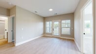 Located at 300 Iron Way in Marysville, Ohio, this 2-bedroom, 1-bathroom residence offers a well-designed single-floor layout with thoughtful finishes throughout. The open-concept living and dining area features light luxury vinyl plank flooring, recessed lighting, and neutral warm-toned walls that create a bright, welcoming atmosphere. A glass-panel door leads out to a private balcony, flanked by windows that invite generous natural light into the space. The kitchen is a standout feature, outfitted with crisp white shaker cabinetry, a hexagonal tile backsplash, quartz countertops, stainless steel appliances, and a large center island with a matte black undermount sink and pendant lighting overhead. A pantry provides additional storage. Both bedrooms are carpeted and include ceiling fans, with the primary bedroom offering a comfortable, well-proportioned layout. The bathroom features a grey vanity with white countertop, a tiled walk-in shower with black-framed glass doors, a separate tub/shower combo, and wood-look flooring. Three closets offer ample storage, and a dedicated laundry area adds everyday convenience. The unit presents a clean, modern aesthetic throughout.