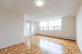 Located at 2677 Kipling Ave in Toronto's northwest end, this 2-bedroom, 1-bathroom unit offers a practical and well-organized layout across a single floor. The space is immediately welcoming, with warm parquet flooring found throughout the hallway, bedrooms, and main living areas, lending a classic character to the interior.

The living area is a standout feature, bathed in natural light from a wide bank of windows that frame open outdoor views of the surrounding neighbourhood and treetops. Baseboard heating runs along the perimeter, ensuring comfortable warmth throughout the seasons.

Both bedrooms are well-proportioned and bright. The primary bedroom benefits from natural light through its own window with outdoor views, while both rooms continue the warm parquet flooring and feature clean, neutral walls offering a versatile canvas.

The bathroom is finished with full white square tile surrounding a bathtub and shower combination, complemented by light tile flooring — clean and functional in design.

A dedicated laundry area adds everyday convenience, while the entry hallway provides a clear and efficient transition into the rest of the unit. Overall, the space presents a clean, functional, and comfortable layout suited for a variety of living arrangements.