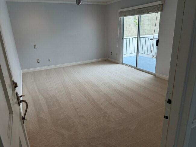View from entry of unit into living room showing balcony 1 - 1649 Appian Way