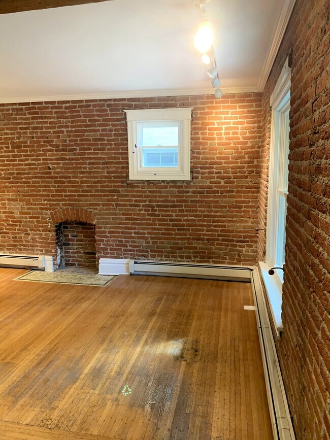 Cozy up by the brick fireplace within an exposed brick wall! - 1638 Adams St