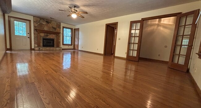 Livingroom with hardwood floors and wood-burning stove - 705 Alcovy Forest Dr