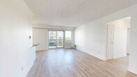 Located at 110 Park Rd N in Oshawa, this well-appointed 2-bedroom, 1-bathroom unit offers a clean, modern aesthetic throughout. Light wood laminate flooring flows seamlessly across all living areas, complementing the crisp white walls and creating a bright, welcoming atmosphere.

The open living room is spacious and filled with natural light, featuring sliding glass doors that lead to a private balcony with views of the surrounding greenery and building complex. The galley-style kitchen is thoughtfully designed with white shaker cabinetry, subway tile backsplash, dark countertops, stainless steel appliances, and recessed lighting — balancing style and functionality.

The generously sized primary bedroom boasts a wide bank of windows that flood the room with sunlight and offer pleasant outdoor views. A dedicated closet space with built-in shelving provides ample storage. The second bedroom is comfortably sized, includes a mirrored sliding-door closet, and features its own window. Two hallways connect the living spaces efficiently, and a dedicated closet adds additional storage convenience.

The bathroom features classic white subway tile surrounding a full soaker tub with an overhead shower, chrome fixtures, and a clean, timeless design. The unit's neutral palette and modern finishes make it a versatile and inviting space.