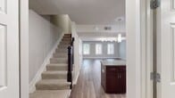 This two-story townhouse in Arbor Park of Alexandria offers a generous 1250 square feet of living space, thoughtfully divided between three bedrooms and four bathrooms. The layout maximizes functionality with a combined kitchen and living room area, creating an open and inviting atmosphere.

The modern kitchen is a standout feature, boasting rich, dark wood cabinetry, stainless steel appliances, and granite countertops. The space is further enhanced by ample natural light streaming through a large window above the sink. Durable wood-look flooring in the kitchen extends into other areas of the home, providing a cohesive and low-maintenance surface.

Bedrooms are well-appointed, with the primary suite offering a spacious 180 square feet. Each room features plush carpeting, ceiling fans for comfort, and large windows that flood the spaces with natural light. Built-in closets provide ample storage solutions.

Bathrooms are designed with practicality in mind, featuring neutral tiled surrounds and modern fixtures. The home's multiple levels are connected by two staircases, ensuring easy navigation throughout the space. With its blend of style and functionality, this townhouse presents an ideal living solution for those seeking a contemporary home in a prime Alexandria location.