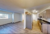 Located at 10500 45 Avenue NW in Edmonton, Alberta, this two-storey, 3-bedroom, 2-bathroom home offers a functional and modern layout across two well-proportioned floors. Light wood laminate flooring runs throughout, creating a bright and cohesive feel in every room.

The main floor houses the kitchen and living areas. The kitchen is equipped with warm wood-tone cabinetry, dark countertops, a subway tile backsplash, stainless steel appliances including a dishwasher and refrigerator, and a modern chandelier overhead. The living room benefits from a large window that draws in natural light and frames outdoor views.

Upstairs, three bedrooms provide comfortable accommodations, each featuring light-filled windows, baseboard heating, and generous closet space — with a total of five closets distributed throughout the home. The primary bedroom includes a dedicated closet with sliding doors and ample room. Both bathrooms are clean and functional, with one featuring a full soaker tub and shower combination with a curved rod.

A dedicated in-suite laundry area with side-by-side washer and dryer adds everyday convenience. Two hallways connect the spaces efficiently, and the overall aesthetic is bright and clean, with white walls and modern black hardware accents tying the design together.