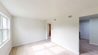 Located on Martin Luther King Jr Blvd in Columbus, Georgia, this single-story 3-bedroom, 1-bathroom home offers a clean, updated interior with a cohesive and bright design throughout. Light wood-tone flooring runs consistently across the living spaces, reflecting natural light and contributing to an airy, welcoming atmosphere.

The kitchen stands out as a highlight of the home, featuring white shaker-style cabinetry, granite-look countertops, a subway tile backsplash, and a full suite of black appliances including a gas range, microwave, dishwasher, and refrigerator. A single-basin sink and recessed lighting complete the functional, modern layout.

The spacious primary bedroom offers ample room and connects conveniently to the hallway, while the two additional bedrooms each include ceiling fans with light fixtures and windows that bring in natural light and outdoor views. One of the secondary bedrooms also features a closet with built-in shelving.

The bathroom is tastefully renovated with large marble-look tile lining the tub surround and flooring, complemented by brass fixtures, a soaking tub, and a window that provides natural ventilation. Clean white walls and neutral tones throughout the home create a versatile, move-in-ready canvas.