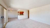 Located at 610 Towne Center Dr in Joppa, MD, this one-bedroom, one-bathroom residence offers a thoughtfully designed single-floor layout that maximizes comfort and functionality. The open-concept living and dining area is carpeted throughout and filled with natural light from large windows and a sliding glass door that leads to a private balcony with outdoor views — an ideal space for relaxing or entertaining.

The kitchen features warm wood cabinetry, dark countertops, a pass-through breakfast bar with track lighting overhead, and wood-look flooring. White appliances including a gas range, dishwasher, and refrigerator complete the functional cooking space.

The generously sized bedroom is carpeted and bathed in natural light from dual windows. It includes access to two closets — one of which is a spacious walk-in closet equipped with built-in shelving and hanging rods, providing ample storage.

The bathroom is well-equipped with a tiled tub/shower combination, a white vanity with sink, and wood-look flooring. A convenient stacked washer and dryer unit is integrated directly into the bathroom, adding everyday practicality. The neutral color palette and clean finishes throughout the space create a bright, move-in-ready atmosphere.