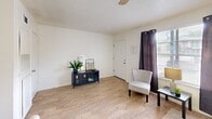 Located at 994 S Kenilworth Pkwy in Baton Rouge, Louisiana, this one-bedroom, one-bathroom unit offers a practical and efficiently designed single-floor layout. The living room features light wood-style flooring, neutral white walls, and a ceiling fan, creating a bright and airy atmosphere. Natural light filters in through windows dressed with dark curtain panels, adding contrast to the clean, understated aesthetic. A dedicated entry area provides a welcoming transition into the space.

The kitchen is equipped with a white range, warm wood-toned cabinetry, and a functional layout that makes efficient use of the available space. A pass-through or counter area connects it to the main living zone, enhancing the open feel of the unit.

The bedroom is a comfortable size, featuring light wood-style flooring, a textured ceiling, a ceiling fan with light fixture, and a mirrored sliding-door closet that adds depth and storage. Windows allow natural light in while maintaining privacy.

The bathroom includes a single-sink vanity with warm wood cabinetry, a wall mirror with overhead lighting, a tub-shower combination, and light flooring that ties the space together cohesively. Overall, the unit presents a clean, functional design suited for comfortable everyday living.
