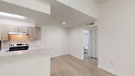 Located at 10571 SW 156th Pl in Miami, FL, this one-bedroom, one-bathroom unit offers a thoughtfully designed layout with modern finishes throughout. Light wood-style flooring flows across the main living areas, creating a bright and cohesive aesthetic complemented by crisp white walls and a textured ceiling.

The kitchen is a standout feature, showcasing warm wood-tone cabinetry, speckled stone countertops, and stainless steel appliances including a range, refrigerator, and dishwasher. A peninsula with a built-in sink adds extra counter space and connects the kitchen to the open living area, making it well-suited for both cooking and entertaining.

The living area is open and airy, with recessed lighting and clear sightlines that maximize the sense of space. A pass-through view into the bathroom is visible from the main area, reflecting the efficient and connected floor plan.

The bedroom is carpeted for comfort and receives natural light through a window with outdoor greenery views, adding a serene touch. A closet provides convenient storage within the room.

The bathroom is clean and functional, featuring a vanity with stone-topped counters, wood-tone cabinetry, a full tub-shower combination with tiled surround, and wood-style flooring that ties into the rest of the home's design palette.