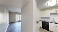 Located at 314 McBrien Rd in Chattanooga, TN, this 2-bedroom, 1-bathroom single-story home offers a well-designed layout with consistent wood-look flooring and a neutral color palette throughout. The combined kitchen and living area forms the heart of the home. The kitchen is equipped with white cabinetry, dark countertops, a white subway tile backsplash, and black appliances including a refrigerator, dishwasher, and range. The living room benefits from natural light streaming through double French doors, adding an airy, open feel to the space. The primary bedroom is generously sized and features a built-in closet with wire shelving, providing practical storage. The second bedroom includes a window that brings in natural light and ample wall space. The full bathroom offers a tub-shower combination, toilet, and a towel warmer bar. A dedicated laundry room includes wall-mounted hookups for added convenience. The entrance and hallway connect all rooms efficiently, contributing to a cohesive flow. Clean white trim, soft neutral walls, and durable flooring are consistent throughout, giving the home a tidy, move-in-ready appearance well-suited for comfortable everyday living.