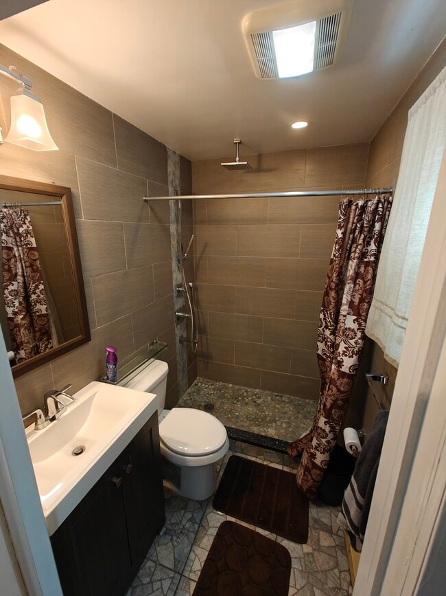 Downstairs bathroom with rain shower and turquoise stone floor . - 29 Peter Way