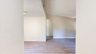 Located at 5122 E Olive Ave in Fresno, CA, this 2-bedroom, 2-bathroom unit offers a well-designed single-level layout with modern updates throughout. Light vinyl plank flooring flows consistently across every room, complemented by neutral warm-beige walls and textured ceilings that create a clean, cohesive aesthetic.

The kitchen is a standout feature, showcasing white cabinetry, granite countertops, a mosaic tile backsplash, stainless steel appliances including a refrigerator and range, and a window that draws in natural light. The open hallway connects the living area to the private bedrooms, providing a practical and efficient flow.

Both bedrooms are comfortably sized with large windows that offer views of surrounding greenery and the neighborhood. The primary bedroom includes a double sliding-door closet for ample storage. The second bedroom also features natural light and a closet.

Each bathroom is finished with granite-topped vanities, sage-green cabinetry, and light flooring. The full bath includes a tub-shower combo with a crisp white surround. A second bathroom with matching finishes serves the primary bedroom. Throughout the unit, white trim and understated details contribute to a fresh, move-in-ready appearance.