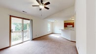 Located in Farmington, MO, this well-organized single-floor, 2-bedroom, 1-bathroom home offers a practical and comfortable layout. The open-concept living and dining area serves as the heart of the home, featuring plush carpeting, a ceiling fan with light fixture, and a sliding glass door that opens to a private outdoor deck with views of surrounding greenery. Natural light fills the space through multiple windows, creating a bright and welcoming atmosphere.

The kitchen flows directly from the living and dining area, connected by a peninsula-style breakfast bar with a white countertop. Warm cherry-toned cabinetry lines the walls, complemented by tile flooring and standard white appliances, including a range and refrigerator. A closet within the kitchen provides additional storage.

Both bedrooms are carpeted and feature natural light from windows overlooking mature trees. Each room is served by sliding wood-panel closets with wire shelving, offering ample storage. The full bathroom includes a single-sink vanity with wood cabinetry, tile flooring, and a tub-shower combination. A dedicated laundry room provides washer and dryer hookups alongside an electrical panel, while a utility room adds further functionality to this efficiently designed home.