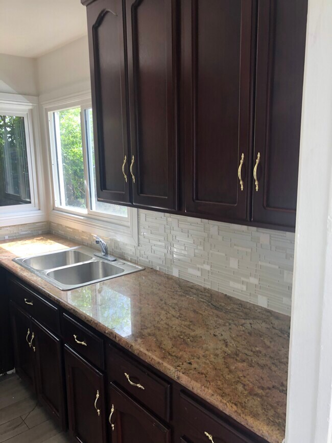 newly renovated kitchen with countertop and glass mosaic tiles - 1815 S La Brea Ave
