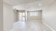 Located at 311 S Sunrise Way in sunny Palm Springs, California, this two-bedroom, two-bathroom single-floor residence offers a clean, modern aesthetic throughout. Light wood-look flooring flows consistently across all rooms, creating a cohesive and airy feel. The living room is a bright, open space featuring a ceiling fan, recessed lighting, a textured ceiling, and a sliding glass door leading to a private balcony — an ideal feature for enjoying the Palm Springs climate. A secondary window allows additional natural light into the room.

The kitchen is efficiently designed with white shaker-style cabinetry, gray quartz-style countertops, stainless steel appliances including a refrigerator, and a built-in dishwasher. Both bedrooms are well-proportioned, with the primary bedroom offering a ceiling fan and a dedicated walk-in closet outfitted with built-in shelving and hanging rods.

Each bathroom is finished with white shaker vanity cabinetry, dark countertops, undermount sinks, brushed nickel hardware and towel rings, and light tile-look flooring, presenting a consistent and polished look. A hallway connects the rooms, providing a practical and organized layout. The neutral color palette throughout lends the space a calm, move-in-ready atmosphere.