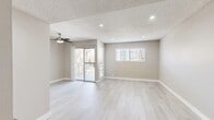 Located at 311 S Sunrise Way in sunny Palm Springs, California, this two-bedroom, two-bathroom single-floor residence offers a clean, modern aesthetic throughout. Light wood-look flooring flows consistently across all rooms, creating a cohesive and airy feel. The living room is a bright, open space featuring a ceiling fan, recessed lighting, a textured ceiling, and a sliding glass door leading to a private balcony — an ideal feature for enjoying the Palm Springs climate. A secondary window allows additional natural light into the room.

The kitchen is efficiently designed with white shaker-style cabinetry, gray quartz-style countertops, stainless steel appliances including a refrigerator, and a built-in dishwasher. Both bedrooms are well-proportioned, with the primary bedroom offering a ceiling fan and a dedicated walk-in closet outfitted with built-in shelving and hanging rods.

Each bathroom is finished with white shaker vanity cabinetry, dark countertops, undermount sinks, brushed nickel hardware and towel rings, and light tile-look flooring, presenting a consistent and polished look. A hallway connects the rooms, providing a practical and organized layout. The neutral color palette throughout lends the space a calm, move-in-ready atmosphere.