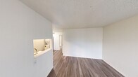 This one-bedroom, one-bathroom unit in Austin, TX offers a well-organized, single-floor layout designed to maximize every square foot. Throughout the space, wood-look plank flooring and crisp white walls create a clean, cohesive aesthetic accented by textured ceilings.

The living room greets you at the entry with a large window that fills the space with natural light, complemented by a front door that provides direct access. It flows seamlessly into the kitchen via a pass-through opening, which adds openness and visual connectivity. The kitchen is outfitted with gray shaker-style cabinetry, white quartz countertops, a tile backsplash, and stainless steel appliances including a range and refrigerator.

The bedroom is a comfortable, well-proportioned retreat featuring a window with blinds, a closet with a hanging rod, and direct access to the bathroom. The full bathroom includes a tub/shower combination with white tile surround, a toilet, and an overhead cabinet for storage.

A notable practical feature is the dedicated in-unit stacked washer and dryer, offering the convenience of on-site laundry. The unit's efficient layout, modern finishes, and functional amenities make it a practical and comfortable option in the heart of Austin.