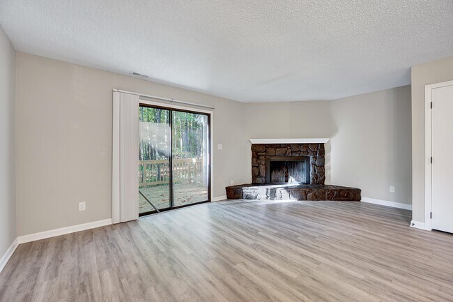 The large living room with a wooded view - 4115 Arckelton Dr