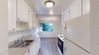 Located at 2537 Kelly St in Hayward, California, this single-floor, one-bedroom, one-bathroom residence offers a practical and comfortable layout. The kitchen is well-appointed with white cabinetry, a stainless steel sink with granite-style countertops, wood-look luxury vinyl flooring, and white appliances including a range and refrigerator. A pendant light fixture hangs above the adjoining dining area, which is brightened by a window with views of lush greenery outside. The living room features carpeted flooring and a textured ceiling, with a sliding glass door that opens to a private outdoor balcony, bringing in abundant natural light and outdoor views. The bedroom is a comfortable, carpeted retreat with a textured ceiling, a window overlooking the exterior, and convenient access to a dedicated closet for storage. The full bathroom is clean and functional, featuring a tiled shower-tub combination, a vanity with a granite-style countertop, white cabinetry, and wood-look flooring. A hallway connects the main living spaces, providing a smooth flow throughout the home. Overall, the residence offers a bright, well-organized living environment in a convenient Hayward location.