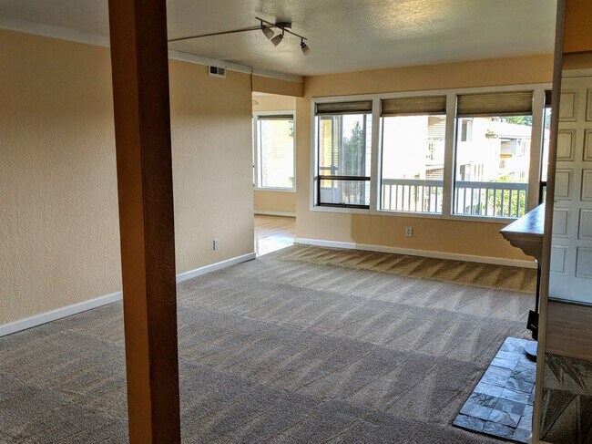 Living room with fireplace and view out to Lake Washington - 11640 100th Ave NE