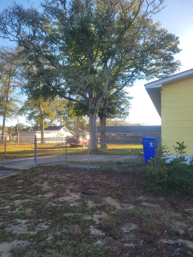 Fenced backyard - 702 E Oak Island Dr