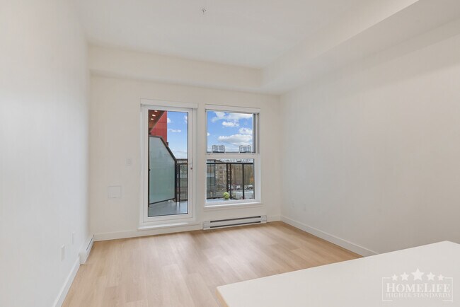 Photo du bâtiment - Modern 1 Bedroom + Den at The District at Willoughby Brand-New, Stylish and Ideally Situated in L...