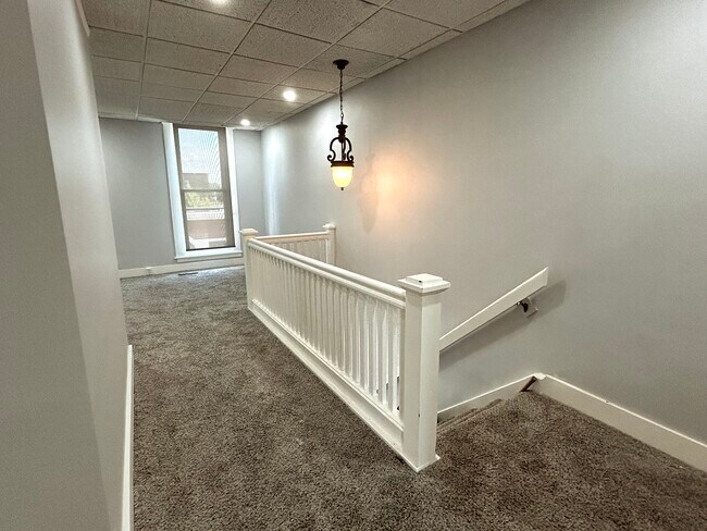Stairs to upper level hallway - 706 E Main St