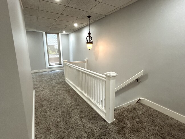 Stairs to upper level hallway - 706 E Main St