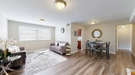 Located at 3253 Walters Ln in District Heights, MD, this well-appointed two-bedroom, one-bathroom single-floor home offers a practical and comfortable layout throughout. The open-concept living and dining area is anchored by warm wood-look flooring and neutral wall tones, creating a bright and welcoming atmosphere. A wide window in the living room allows natural light to fill the space, while the adjacent dining area provides ample room for a full dining set. The kitchen is equipped with rich cherry wood cabinetry, laminate countertops, a gas range, dishwasher, and a window that brings in additional natural light. A hallway connects the main living areas to the two bedrooms, each featuring plush carpeting and closet storage. The spacious primary bedroom offers a generous footprint, while the second bedroom also includes a window with outdoor views and room for a workspace. Two closets provide practical storage throughout. The full bathroom includes a tub-shower combination, a wood-tone vanity with ample counter space, and clean white finishes. A welcoming entry hallway with wood-look flooring completes this efficiently designed, move-in-ready home in the District Heights community.