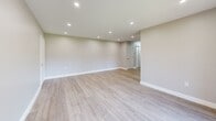 Located at 900 Mickley Rd in Whitehall, PA, this 1-bedroom, 1-bathroom residence offers a clean, modern aesthetic with quality finishes throughout. The open living room is a welcoming centerpiece, featuring light wood-style flooring, recessed lighting, and neutral walls that create a bright and airy atmosphere. A sliding glass door leads to a private balcony overlooking lush green lawns and a wooded backdrop, bringing natural light and serene outdoor views into the main living area. The kitchen is well-equipped with white shaker-style cabinetry, granite countertops, stainless steel appliances including a refrigerator, range, microwave, and dishwasher, plus a window above the sink that adds natural light. The spacious bedroom features soft carpeting, a ceiling fan with lighting, a sizable closet, and a window that keeps the room comfortable and bright. The bathroom is elegantly finished with large-format tile surrounds, a soaking tub with an overhead rain shower, a marble-topped vanity, and chrome fixtures, delivering a refined, spa-like feel. Recessed lighting and consistent neutral tones throughout the residence contribute to a cohesive, modern living environment.