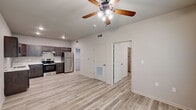 Located at 705 Village Cir in Dublin, Georgia, this thoughtfully designed one-bedroom, one-bathroom unit offers a clean, modern aesthetic throughout its single-floor layout. Light wood-look flooring flows consistently across all rooms, creating a cohesive and bright atmosphere.

The kitchen is a standout feature, outfitted with rich dark espresso shaker-style cabinetry, crisp white countertops, a stainless steel undermount sink, and a full suite of stainless steel appliances including a range and refrigerator. Recessed lighting illuminates the space, and the open layout connects seamlessly to the living area.

The bedroom is a comfortable, well-proportioned room featuring a ceiling fan with light fixture and dual windows that invite generous natural light and views of surrounding greenery. The neutral wall tones and light flooring lend a calm, airy feel to the space.

The bathroom features a full tub and shower surround finished in clean white tile, complemented by wood-look flooring and a gold-toned towel bar for a subtle modern accent.

Storage is a notable highlight, with three closets throughout the unit — including a spacious walk-in style closet equipped with wire shelving, providing abundant organizational capacity. The overall design emphasizes functionality and modern simplicity, making this a well-appointed and practical living space.