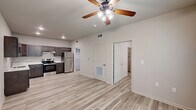 Located at 705 Village Cir in Dublin, Georgia, this thoughtfully designed one-bedroom, one-bathroom unit offers a clean, modern aesthetic throughout its single-floor layout. Light wood-look flooring flows consistently across all rooms, creating a cohesive and bright atmosphere.

The kitchen is a standout feature, outfitted with rich dark espresso shaker-style cabinetry, crisp white countertops, a stainless steel undermount sink, and a full suite of stainless steel appliances including a range and refrigerator. Recessed lighting illuminates the space, and the open layout connects seamlessly to the living area.

The bedroom is a comfortable, well-proportioned room featuring a ceiling fan with light fixture and dual windows that invite generous natural light and views of surrounding greenery. The neutral wall tones and light flooring lend a calm, airy feel to the space.

The bathroom features a full tub and shower surround finished in clean white tile, complemented by wood-look flooring and a gold-toned towel bar for a subtle modern accent.

Storage is a notable highlight, with three closets throughout the unit — including a spacious walk-in style closet equipped with wire shelving, providing abundant organizational capacity. The overall design emphasizes functionality and modern simplicity, making this a well-appointed and practical living space.