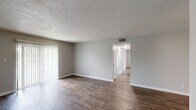 Located at 416 Hay Dr SW in Decatur, Alabama, this single-story, 2-bedroom, 1-bathroom home offers a practical and well-maintained layout with a clean, neutral aesthetic throughout. Dark wood-style vinyl flooring flows consistently across the living spaces, complemented by soft gray walls and white trim for a cohesive, modern look.

The living room is a comfortable gathering space featuring a textured ceiling, a sliding glass door with vertical blinds that invites natural light and outdoor views. The kitchen is efficiently designed with white cabinetry, light stone-patterned countertops, a double-basin sink, a dishwasher, and additional appliances, providing ample functionality.

Both bedrooms are well-proportioned with natural light from windows fitted with blinds. The primary bedroom offers generous space and includes a double-door closet for ample storage. The second bedroom also benefits from a window and easy hallway access. A dedicated closet provides additional storage within the home.

The bathroom features a white vanity with a single-basin sink, a framed mirror, and a multi-bulb light fixture, maintaining the home's clean and understated style. A hallway connects the bedrooms and bathroom efficiently. Overall, this home presents a tidy, functional, and move-in-ready living environment.