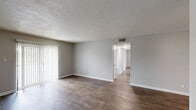 Located at 416 Hay Dr SW in Decatur, Alabama, this single-story, 2-bedroom, 1-bathroom home offers a practical and well-maintained layout with a clean, neutral aesthetic throughout. Dark wood-style vinyl flooring flows consistently across the living spaces, complemented by soft gray walls and white trim for a cohesive, modern look.

The living room is a comfortable gathering space featuring a textured ceiling, a sliding glass door with vertical blinds that invites natural light and outdoor views. The kitchen is efficiently designed with white cabinetry, light stone-patterned countertops, a double-basin sink, a dishwasher, and additional appliances, providing ample functionality.

Both bedrooms are well-proportioned with natural light from windows fitted with blinds. The primary bedroom offers generous space and includes a double-door closet for ample storage. The second bedroom also benefits from a window and easy hallway access. A dedicated closet provides additional storage within the home.

The bathroom features a white vanity with a single-basin sink, a framed mirror, and a multi-bulb light fixture, maintaining the home's clean and understated style. A hallway connects the bedrooms and bathroom efficiently. Overall, this home presents a tidy, functional, and move-in-ready living environment.
