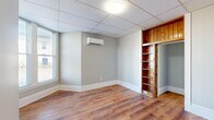 Located at 500 Euclid in Lynchburg, Virginia, this compact yet efficiently laid-out one-bedroom, one-bathroom unit offers a practical and comfortable living arrangement across a single floor. Warm hardwood-style flooring runs throughout the space, providing a cohesive and inviting atmosphere from room to room.

The kitchen is brightened by multiple windows that allow ample natural light to fill the space. White cabinetry pairs cleanly with granite-style countertops and a stainless steel sink, offering functional storage and prep space. Appliances, including a full-size refrigerator and stacked washer and dryer, are conveniently incorporated, making in-unit laundry a notable feature.

The bedroom is a well-proportioned retreat featuring a wall-mounted mini-split system for individual climate control, a built-in wood-finished shelving unit with an adjacent sliding door, and a double-door closet for additional storage. Natural light filters in through windows fitted with blinds.

The bathroom is neatly appointed with a vanity, toilet, and a bathtub/shower combination, accompanied by a window that provides ventilation and natural light. Additional rooms include hallways connecting the layout, and an open unclassified room that offers flexible use. Drop-panel ceilings with flush-mount lighting are consistent throughout the unit.