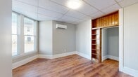 Located at 500 Euclid in Lynchburg, Virginia, this compact yet efficiently laid-out one-bedroom, one-bathroom unit offers a practical and comfortable living arrangement across a single floor. Warm hardwood-style flooring runs throughout the space, providing a cohesive and inviting atmosphere from room to room.

The kitchen is brightened by multiple windows that allow ample natural light to fill the space. White cabinetry pairs cleanly with granite-style countertops and a stainless steel sink, offering functional storage and prep space. Appliances, including a full-size refrigerator and stacked washer and dryer, are conveniently incorporated, making in-unit laundry a notable feature.

The bedroom is a well-proportioned retreat featuring a wall-mounted mini-split system for individual climate control, a built-in wood-finished shelving unit with an adjacent sliding door, and a double-door closet for additional storage. Natural light filters in through windows fitted with blinds.

The bathroom is neatly appointed with a vanity, toilet, and a bathtub/shower combination, accompanied by a window that provides ventilation and natural light. Additional rooms include hallways connecting the layout, and an open unclassified room that offers flexible use. Drop-panel ceilings with flush-mount lighting are consistent throughout the unit.