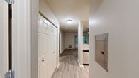 This thoughtfully designed 2-bedroom, 2-bathroom residence in Canton, Michigan offers a functional single-floor layout with a clean, modern aesthetic throughout. The entry hallway welcomes you with wood-style luxury vinyl flooring, a large closet, and a smooth flow into the main living areas.

The kitchen is a standout feature, boasting warm honey-toned cabinetry, granite-style countertops, a white subway tile backsplash, and a full suite of stainless steel appliances including a range, microwave, refrigerator, and dishwasher. A window allows natural light to brighten the space.

The living room is open and airy, highlighted by a ceiling fan, wood-style flooring, and a sliding glass door with vertical blinds that opens to an outdoor view of mature trees, bringing the outdoors in with ample natural light.

Both bedrooms are carpeted for comfort and feature windows with wooded views, providing a peaceful retreat. The primary bedroom offers a generous footprint with good closet access.

The two bathrooms are finished consistently with granite-topped vanities, wood-style flooring, and clean white tub-shower combinations with brushed nickel fixtures. A central hallway connects all rooms, enhancing the efficient and cohesive flow of the layout.