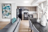 Located at 532 Bay St in the heart of downtown Toronto, this well-appointed suite offers a thoughtfully designed single-floor layout that balances comfort and functionality. The open-concept living and dining area is bright and welcoming, featuring light hardwood flooring, large floor-to-ceiling windows that frame urban city views, and ample space for both relaxing and entertaining. The kitchen is efficiently laid out with warm wood-toned cabinetry, stainless steel appliances including a dishwasher and range, a stainless steel sink, and generous counter space. Natural light filters in through a large window, enhancing the clean, modern aesthetic. The unit includes two well-sized bedrooms, each with large sliding glass windows offering city views and light hardwood floors. The primary bedroom features an expansive window wall that fills the room with natural light. Two full bathrooms serve the suite, both finished with tile flooring, wood-toned vanities, soaker tubs with shower fixtures, and built-in shelving. A hallway lined with framed artwork connects the living spaces and features a stacked in-suite washer and dryer, adding everyday convenience. The overall design is clean and contemporary, with a neutral colour palette throughout.
