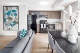 Located at 532 Bay St in the heart of downtown Toronto, this well-appointed suite offers a thoughtfully designed single-floor layout that balances comfort and functionality. The open-concept living and dining area is bright and welcoming, featuring light hardwood flooring, large floor-to-ceiling windows that frame urban city views, and ample space for both relaxing and entertaining. The kitchen is efficiently laid out with warm wood-toned cabinetry, stainless steel appliances including a dishwasher and range, a stainless steel sink, and generous counter space. Natural light filters in through a large window, enhancing the clean, modern aesthetic. The unit includes two well-sized bedrooms, each with large sliding glass windows offering city views and light hardwood floors. The primary bedroom features an expansive window wall that fills the room with natural light. Two full bathrooms serve the suite, both finished with tile flooring, wood-toned vanities, soaker tubs with shower fixtures, and built-in shelving. A hallway lined with framed artwork connects the living spaces and features a stacked in-suite washer and dryer, adding everyday convenience. The overall design is clean and contemporary, with a neutral colour palette throughout.